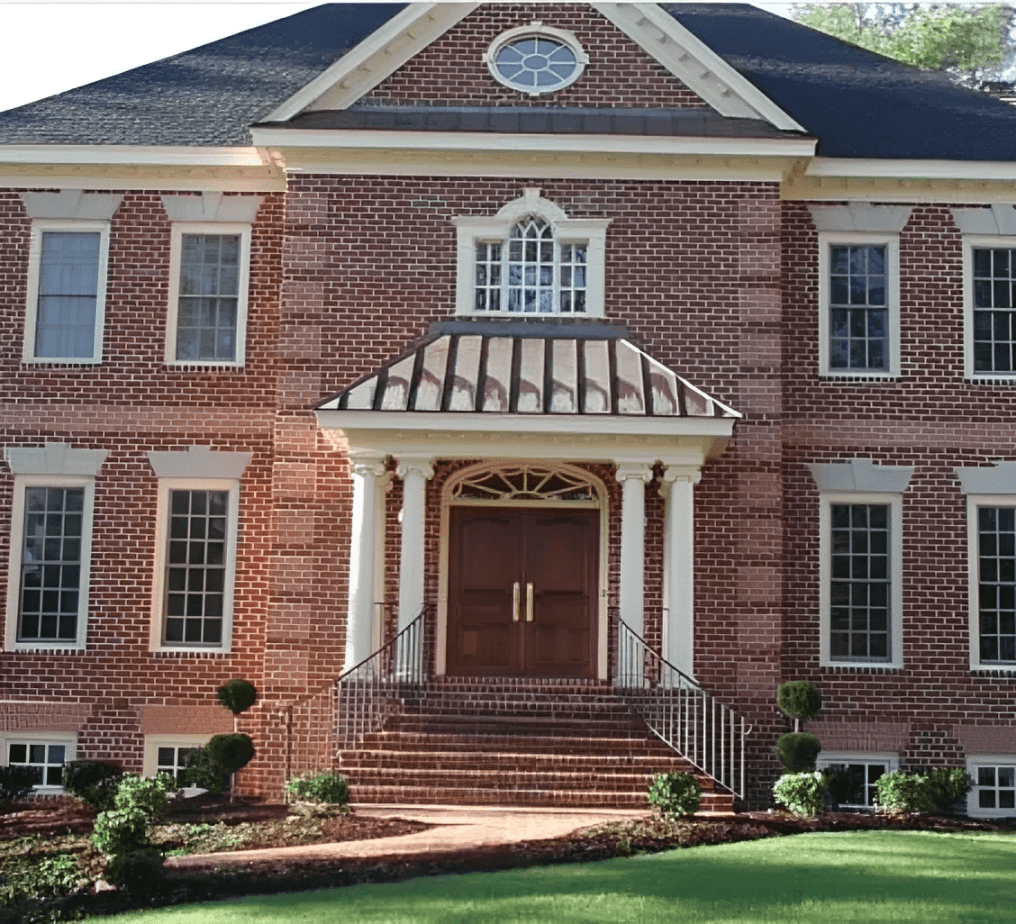 Two-story brick home with lush lawn