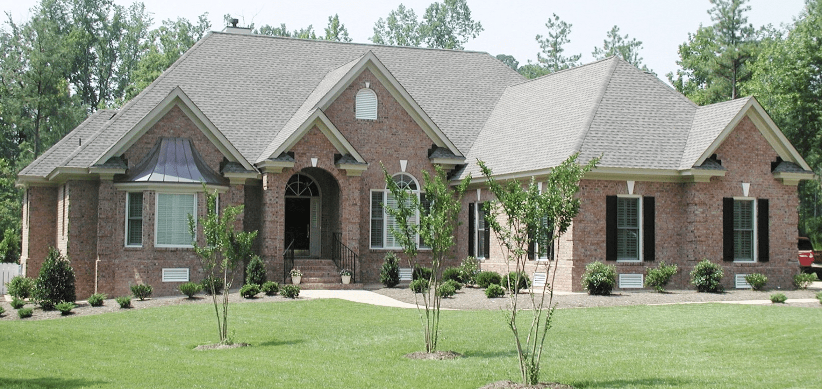 Single-story brick home with arched entrance